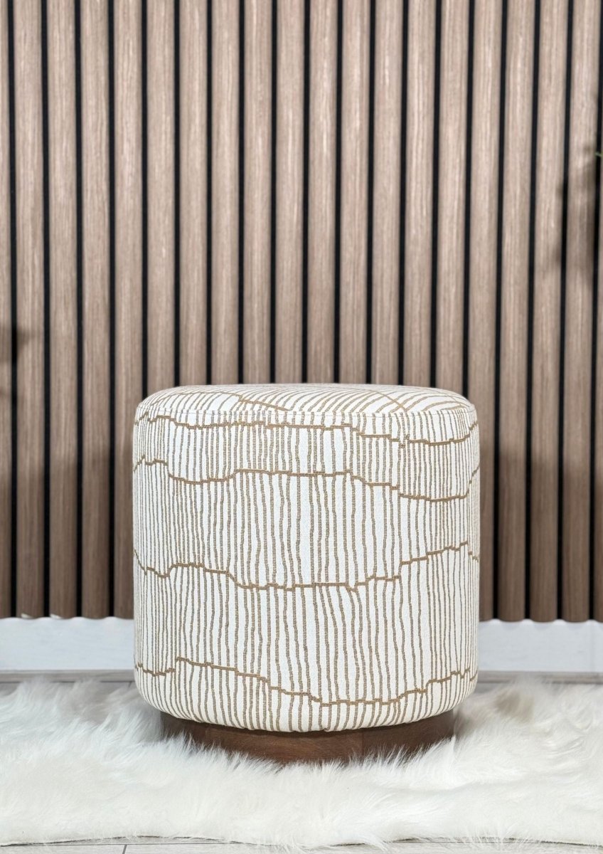 "Patterned pouf in neutral tones with brown cushioned base"