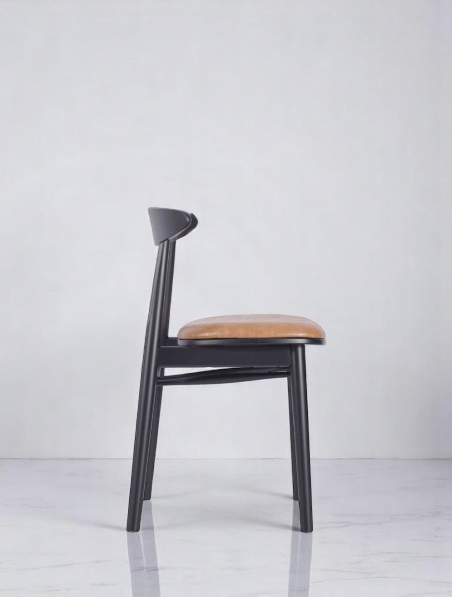 "Modern black base side chair with brown leather cushion in Italian design"