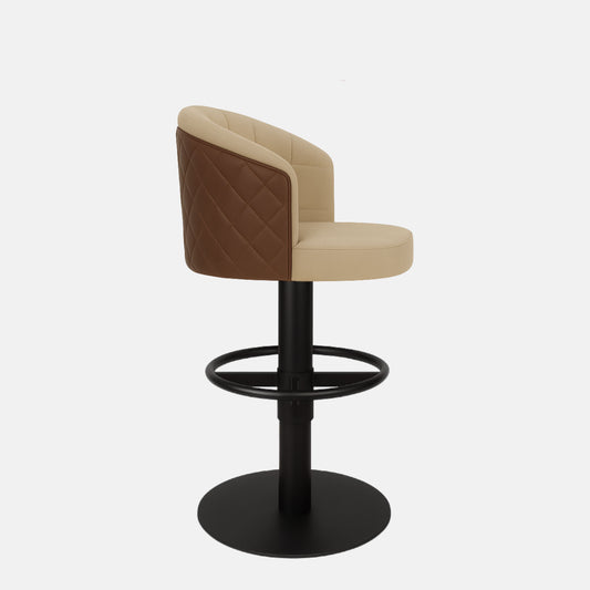 Two-tone beige and brown upholstered bar stool with quilted back, curved design, and black pedestal base with circular footrest.