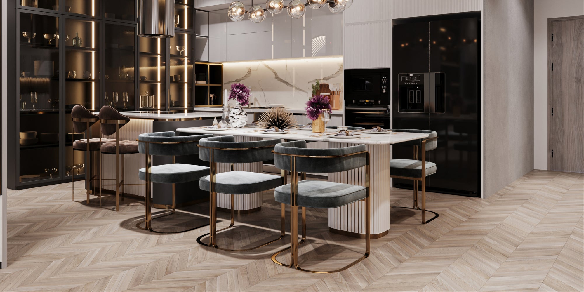 Modern kitchen and dining area with a large island and marble backsplash, featuring grey velvet chairs with gold frames around a white dining table, pendant lighting overhead, and dark cabinetry with integrated lighting.