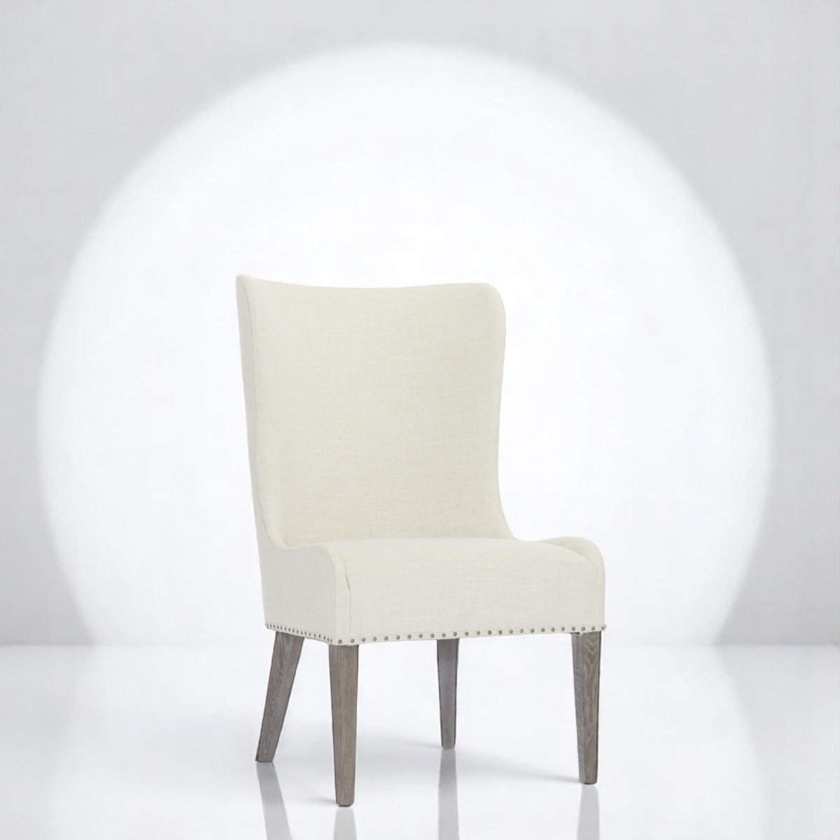 alt="Cream side chair with flowing line design and soft grey legs, offering a cozy home feel"