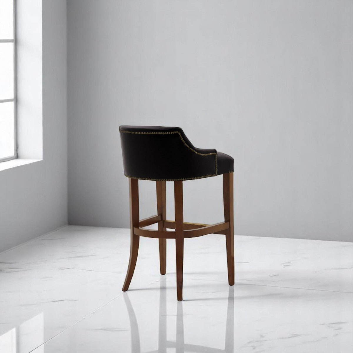 alt="Stylish black bar stool with leather upholstery and medium oak wood legs, perfect for contemporary spaces"