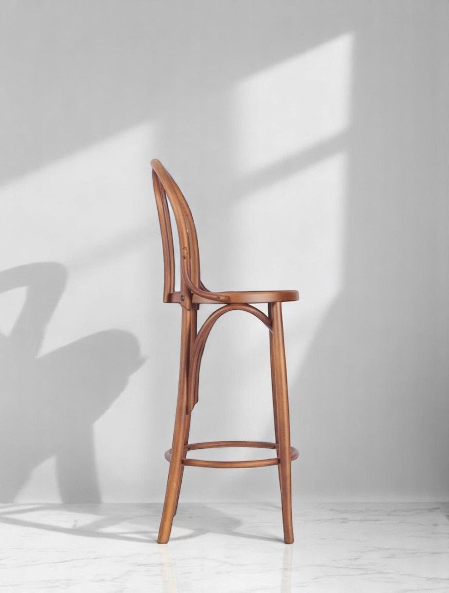 alt="Natural oak wooden bar stool featuring a traditional bentwood silhouette"