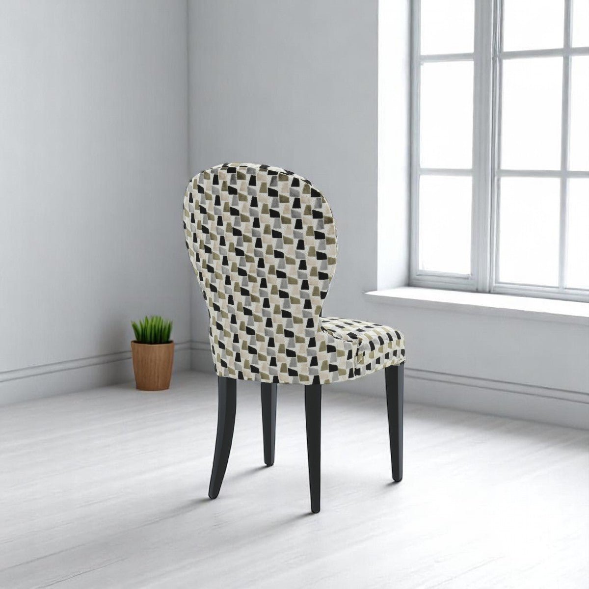 alt="Stylish full-upholstered back dining chair with patterned fabric seat and black wood legs"