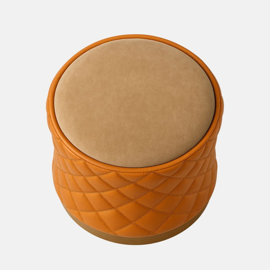 Tan quilted leather and beige velvet round stool with brass base modern upholstered ottoman or vanity seat for living room, bedroom, or hotel interiors.