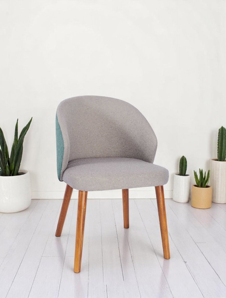 alt="Modern office chair with grey soft fabric seat, contrasting green backrest, and medium oak legs"