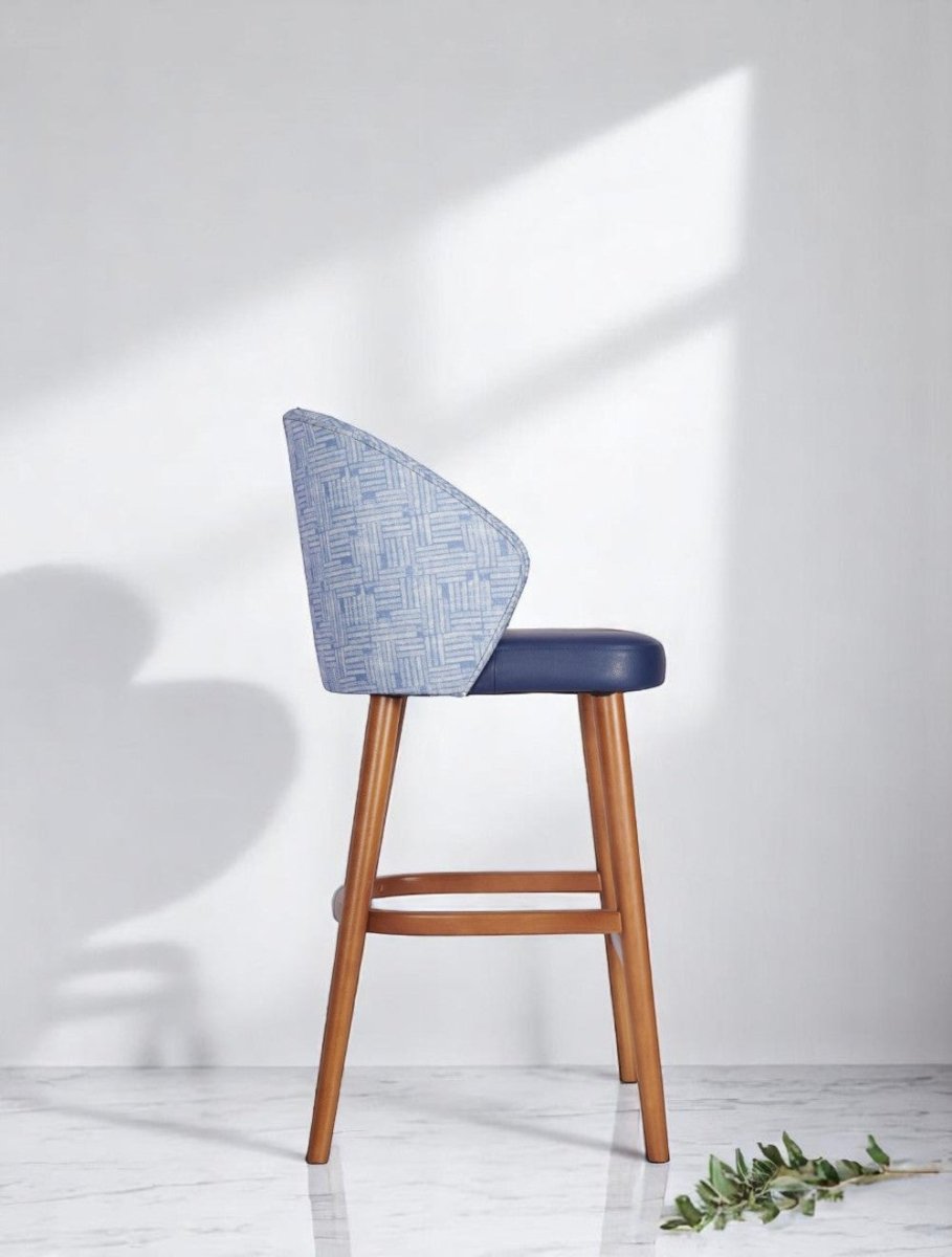 alt="Elegant blue kitchen stool with fabric back design, leather upholstered seat, and medium oak wood base"