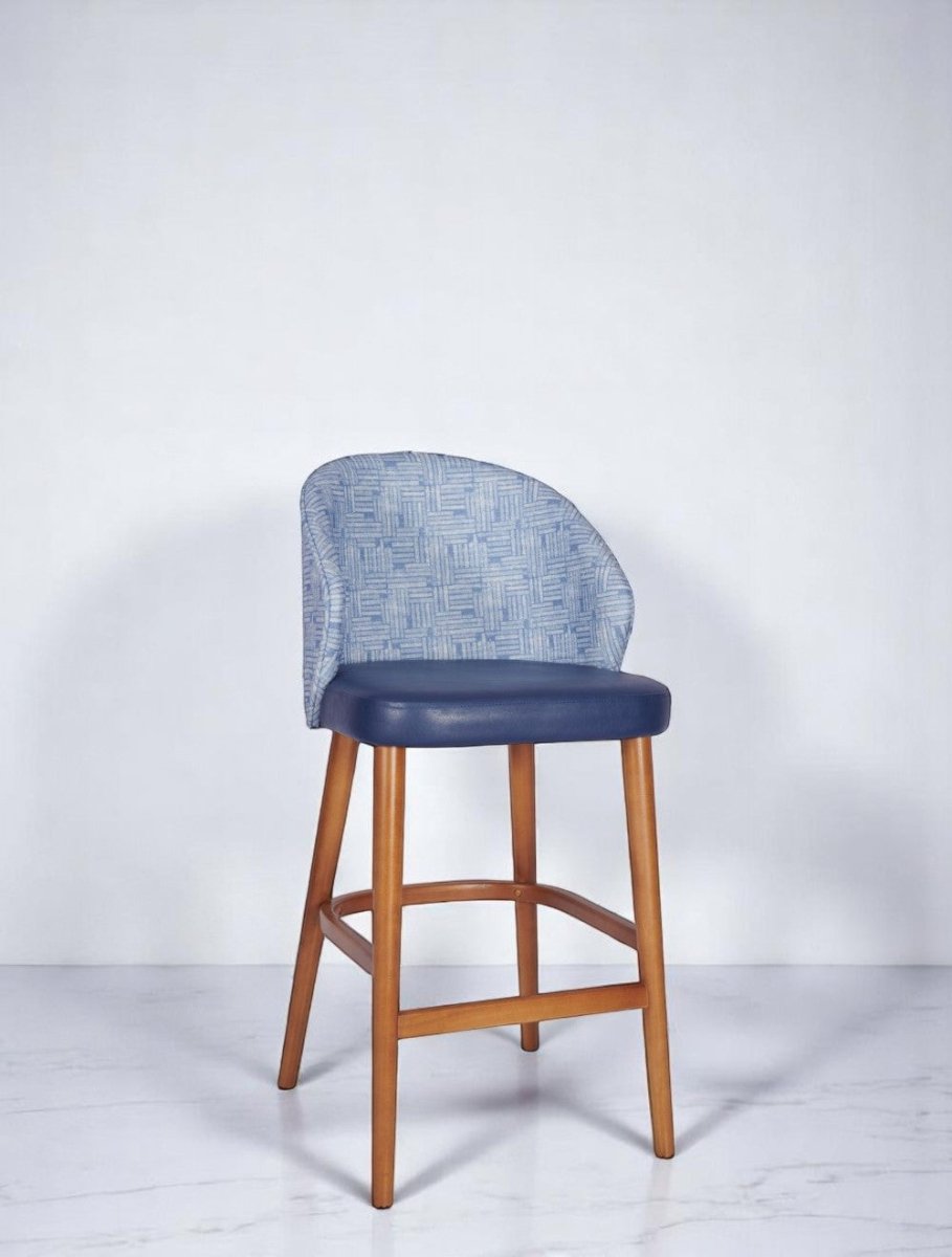 alt="Modern blue kitchen stool with soft leather seat and unique designer fabric back on medium oak legs"