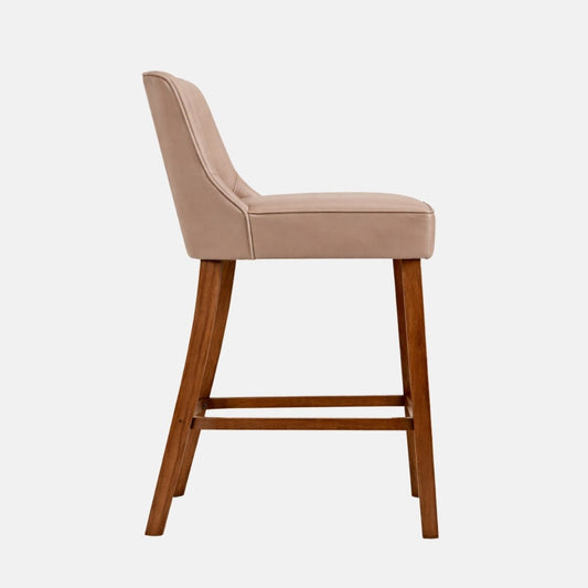 Tan upholstered bar stool with padded seat and backrest, modern design with wooden legs side view