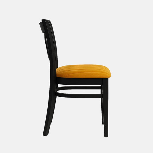 Black wooden dining chair with a cross-back design and mustard yellow upholstered seat on a white background