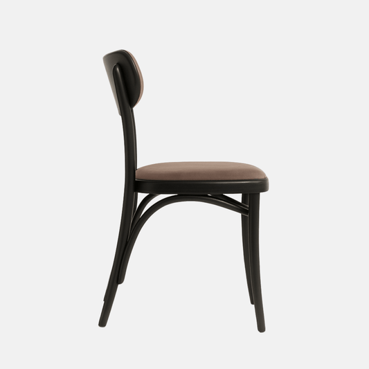 A side view of a modern chair with a black wooden frame and brown upholstered seat and backrest, set against a light beige background. The chair features gently curved legs and a sleek, minimalist design.