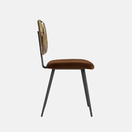 Modern dining chair with black tapered metal legs, a brown velvet seat, and a geometric-patterned upholstered backrest in neutral earth tones.