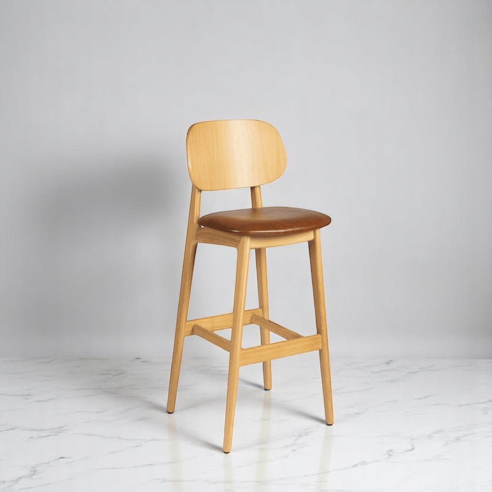 alt="Stylish Italian-style bar stool with upholstered seat and smooth natural oak finish"