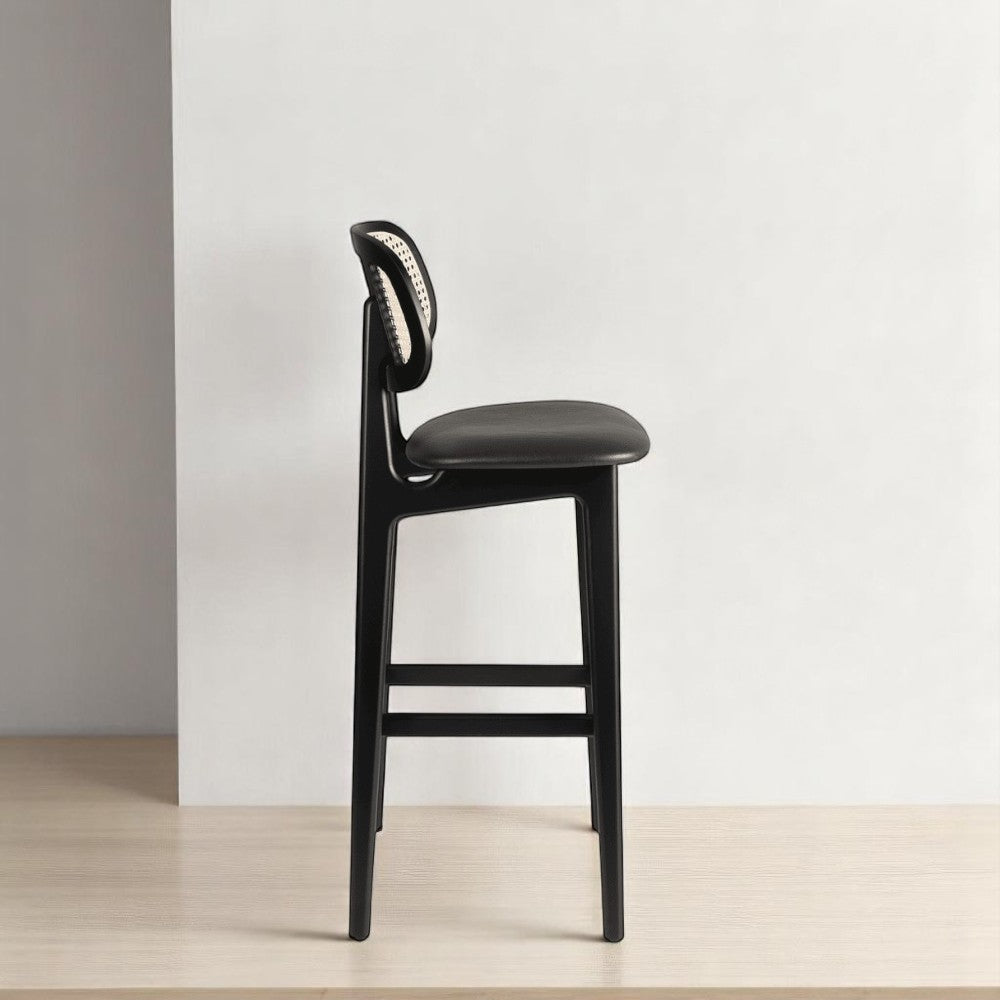 alt="Sleek kitchen stool with black wood frame, rattan backrest, and black leather seat for a sophisticated look"