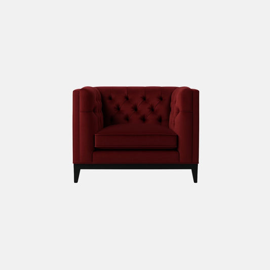 That’s a burgundy tufted one seat sofa with a deep-buttoned back and sides — a design that resembles a modern Chesterfield. It has one seat cushion, straight square arms, and a solid dark wood base with tapered legs.