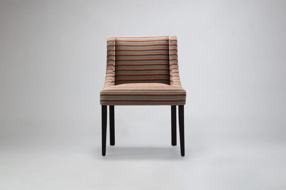 alt="Contemporary square accent chair featuring bold patterned fabric and sleek modern design"