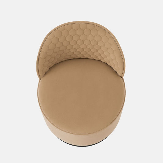 Beige velvet vanity chair with quilted hexagonal backrest and black round base modern upholstered accent chair for bedroom, dressing area, or hotel suite.