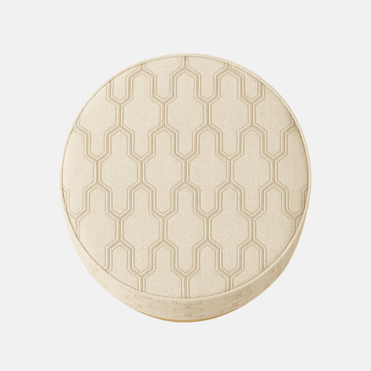 Round beige ottoman with geometric textured upholstery and a gold metallic base.