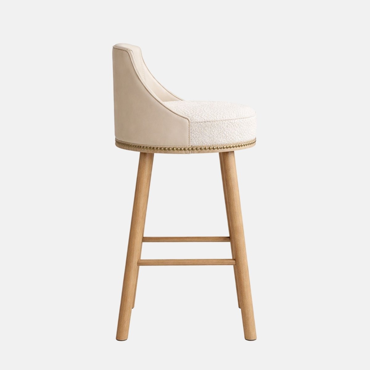 Modern bar stool with cream upholstered seat and curved backrest, featuring studded trim and light wooden legs, ideal for bars and hospitality interiors