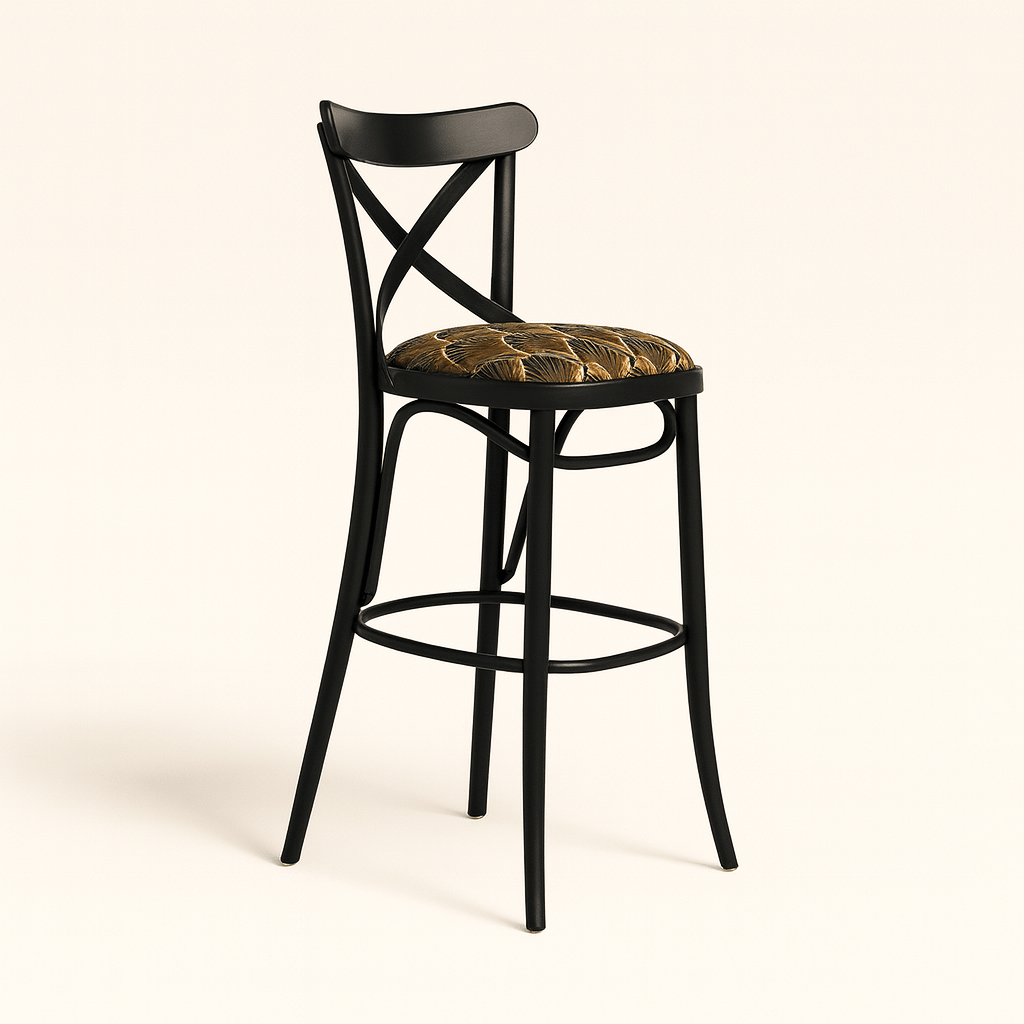 A modern black wooden barstool with an X-shaped backrest and gently curved legs, featuring a round cushioned seat upholstered in a gold and brown Art Deco patterned fabric, set against a plain beige background with a soft shadow.
