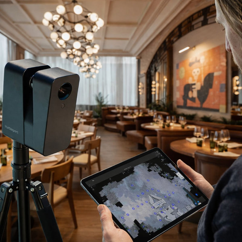Person using a 3D scanning camera and tablet to map a restaurant interior