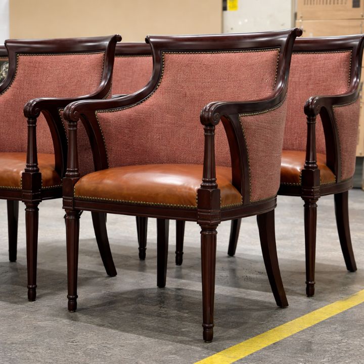 Traditional dining armchair with brown leather seat and upholstered fabric backrest, featuring carved wooden frame, ideal for restaurants and classic interiors
