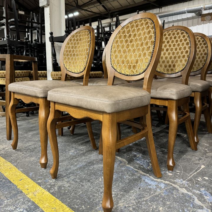 Classic wooden dining chair with oval patterned backrest and upholstered seat, featuring carved legs, ideal for restaurants and traditional interiors