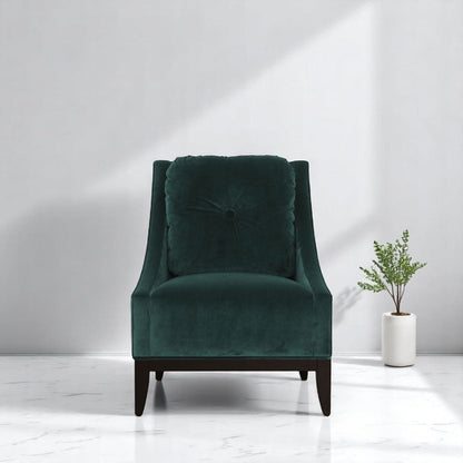 alt="Modern green lounge chair with square soft cushion and black wood legs in a cozy living space"