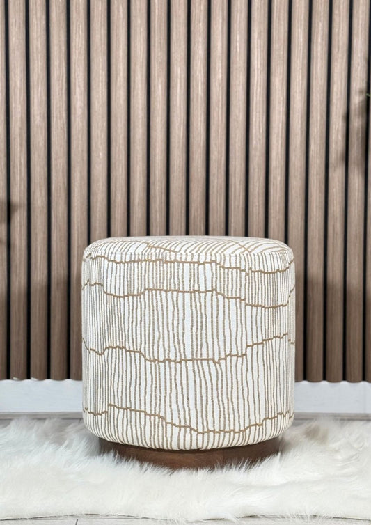 "Patterned pouf in neutral tones with brown cushioned base"