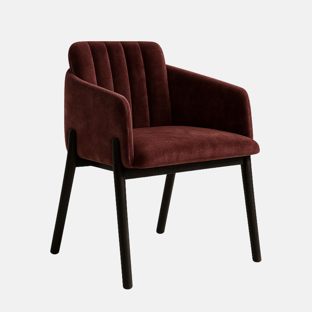 Contemporary armchair with a dark wooden frame and legs, featuring a deep burgundy velvet upholstered seat, backrest, and sides with vertical channel stitching, set against a light grey background