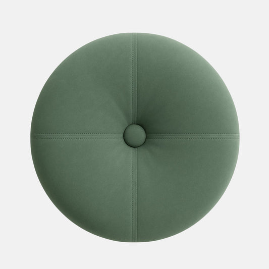 Round upholstered ottoman with a tufted top in soft sage green fabric, accented by visible stitching and a dark wooden base. The design is modern and elegant with a smooth, cushioned finish