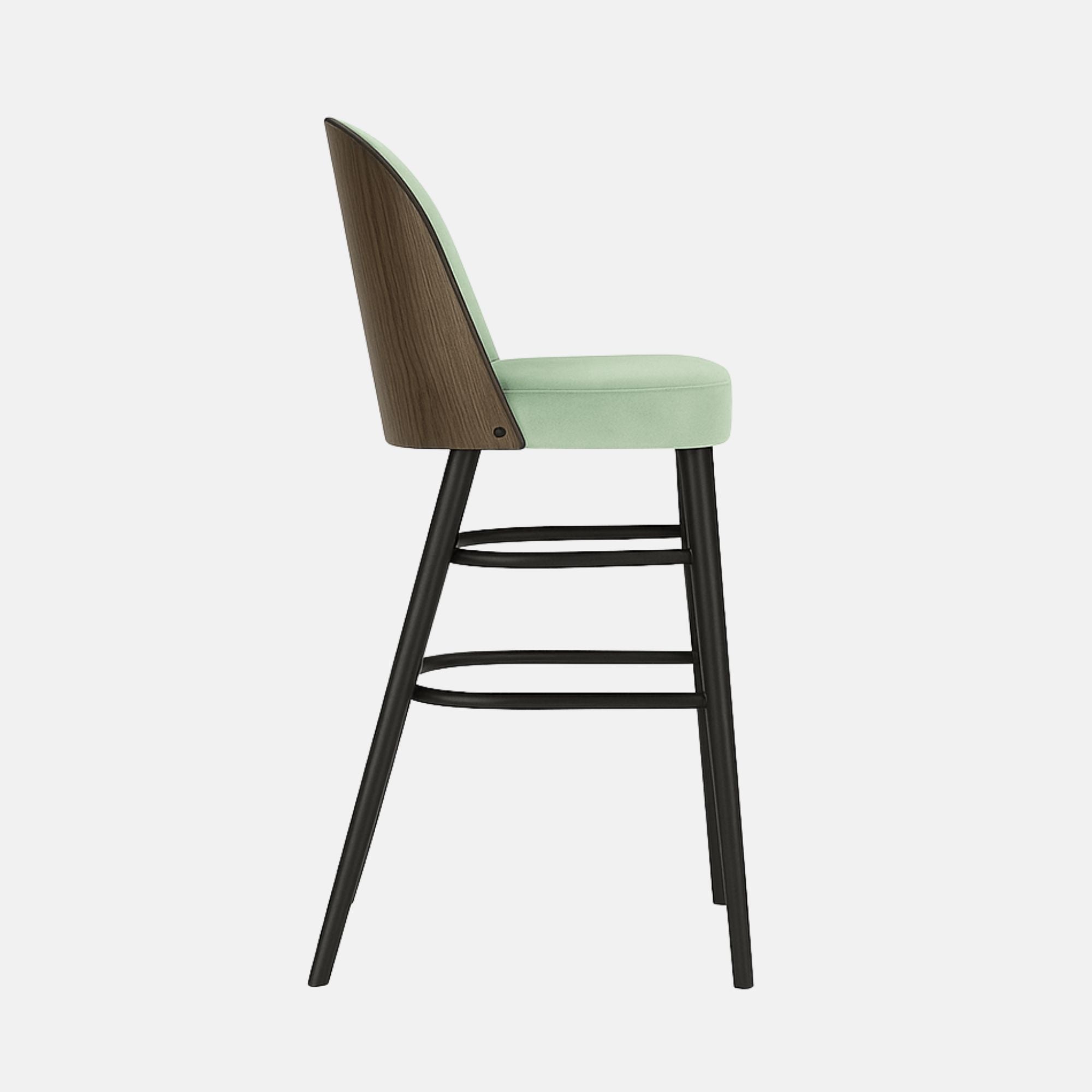 Modern bar stool with a light green upholstered seat and rounded backrest, supported by slim black wooden legs with curved double footrests.
