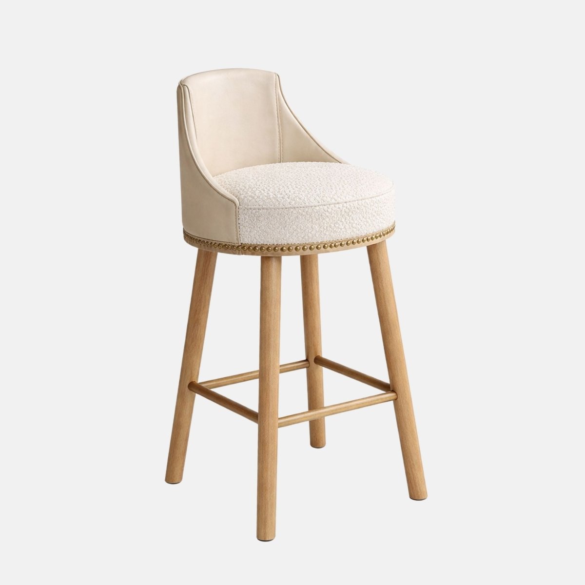 Elegant bar stool with cream upholstered seat and curved backrest, featuring studded trim and light wooden legs with footrest, ideal for bars and hospitality interiors
