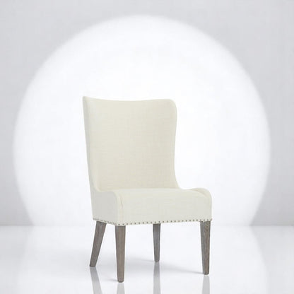 alt="Cream side chair with flowing line design and soft grey legs, offering a cozy home feel"