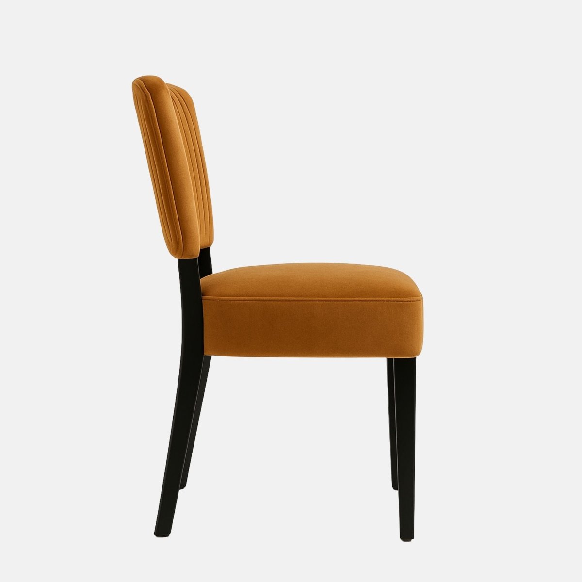 Modern dining chair upholstered in burnt orange velvet with vertical channel-tufted backrest and black wooden legs – handmade contemporary seating