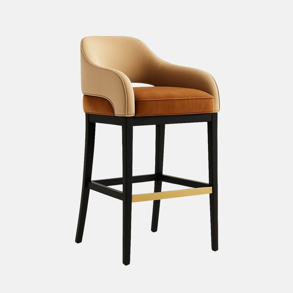 Modern bar stool with a curved backrest and arm design, upholstered in light beige leather with a cushioned rust-orange velvet seat. The chair features a black wooden frame with a brass footrest accent, combining comfort with contemporary elegance