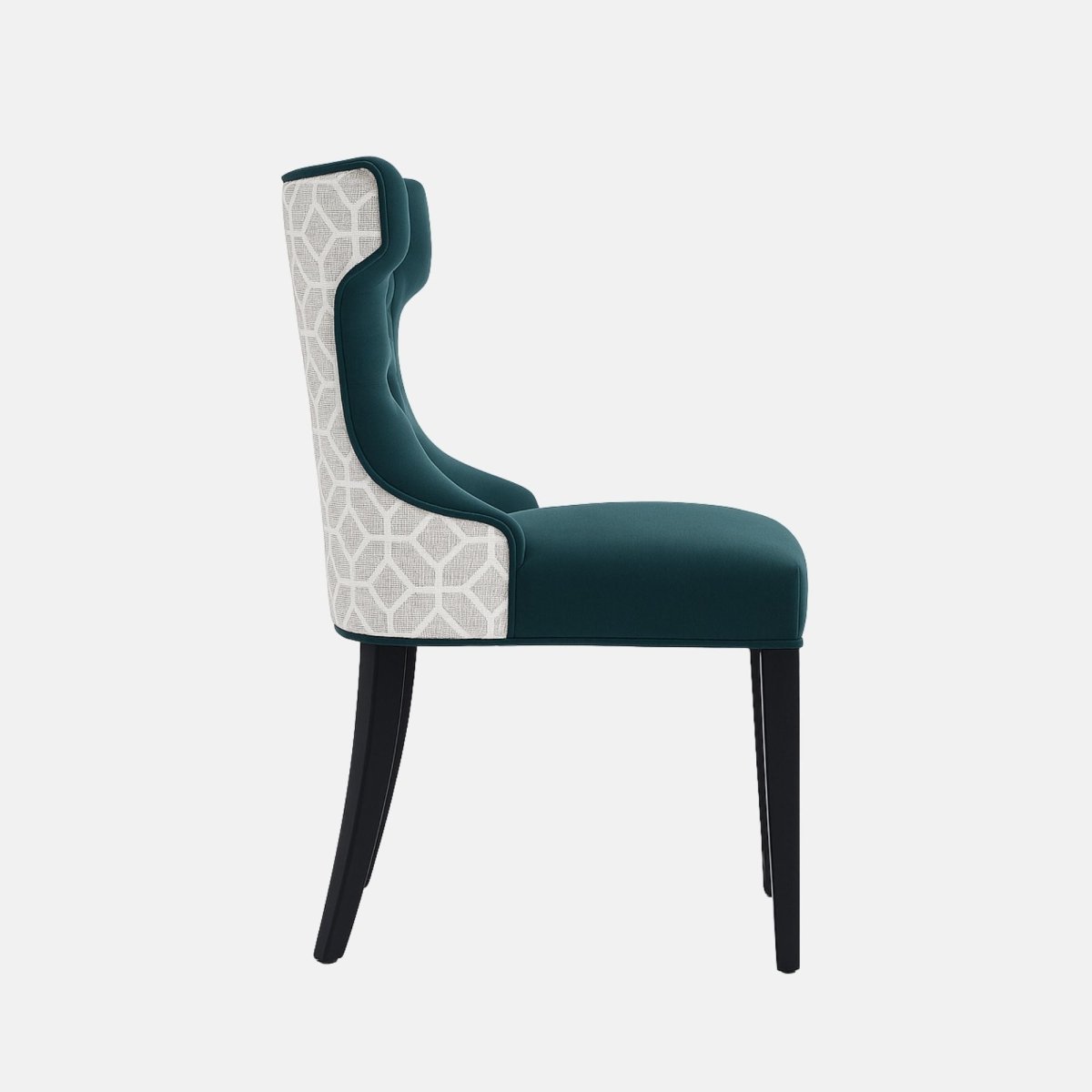 A modern accent chair with deep teal tufted upholstery on the seat and inner backrest, paired with a lighter geometric patterned fabric on the outer backrest. The chair has sleek black wooden legs, combining classic and contemporary design elements.