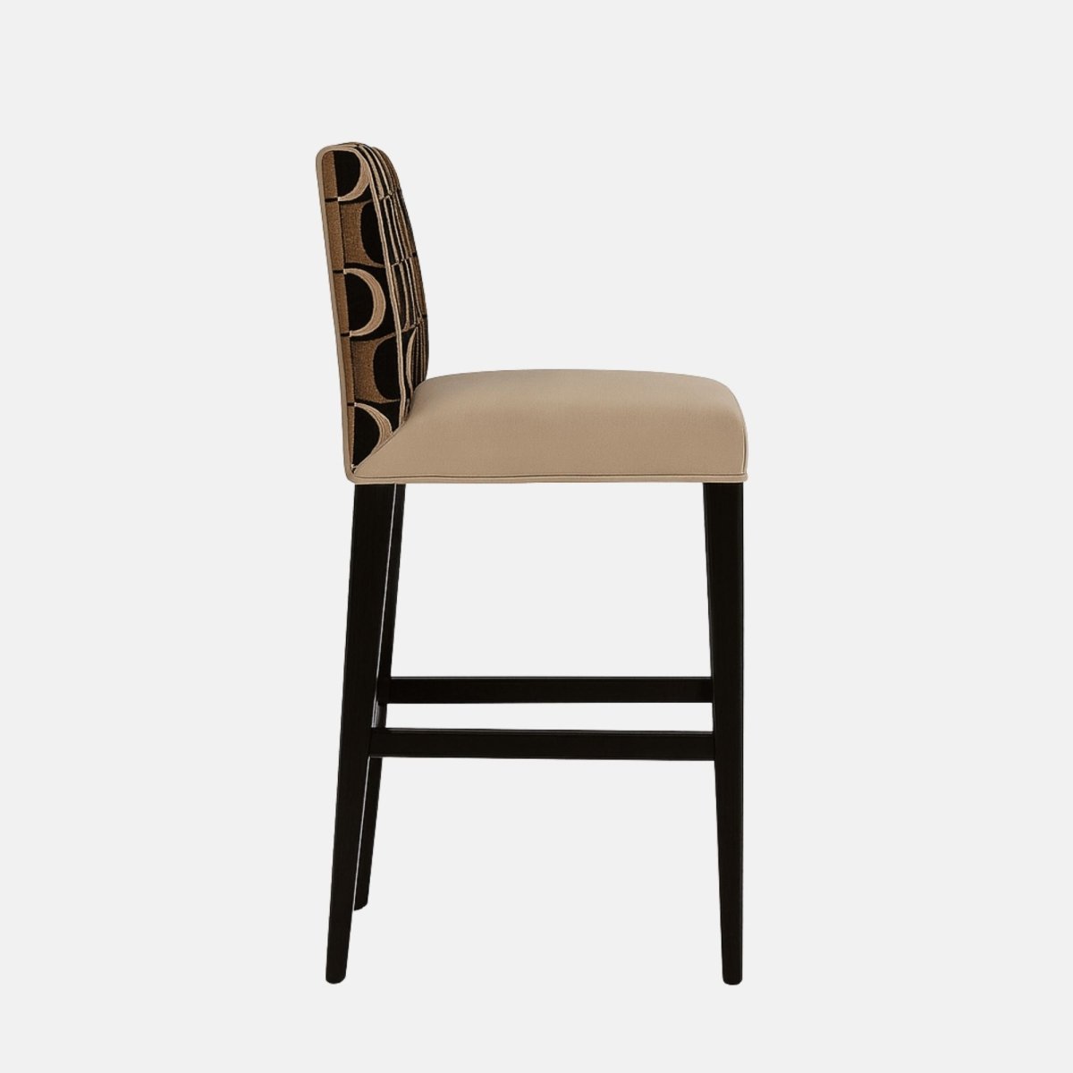 Modern bar stool with beige cushioned seat, black wooden legs with gold footrest detail, and a low rectangular backrest upholstered in a geometric black and gold circle pattern.