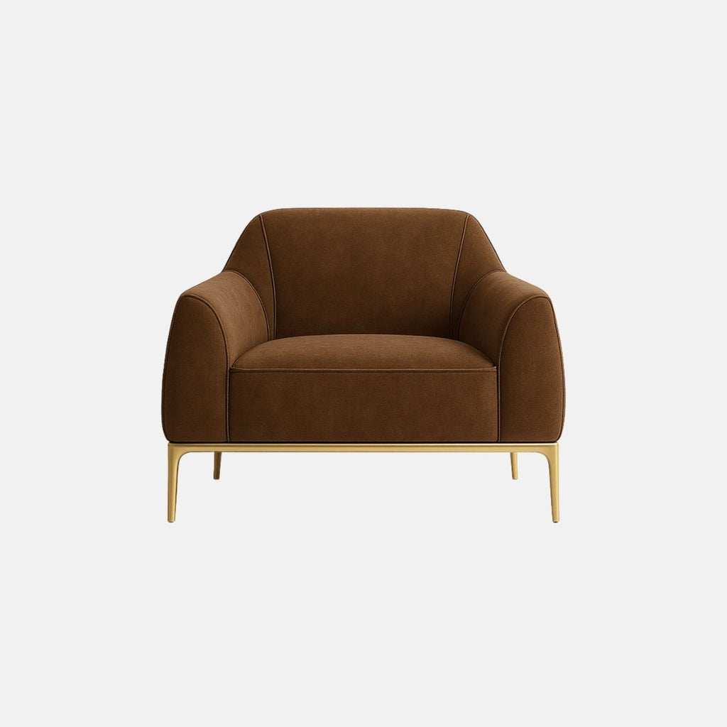 Contemporary armchair upholstered in rich brown fabric with smooth, rounded armrests and clean lines. It features slim gold metal legs that add an elegant, modern touch.