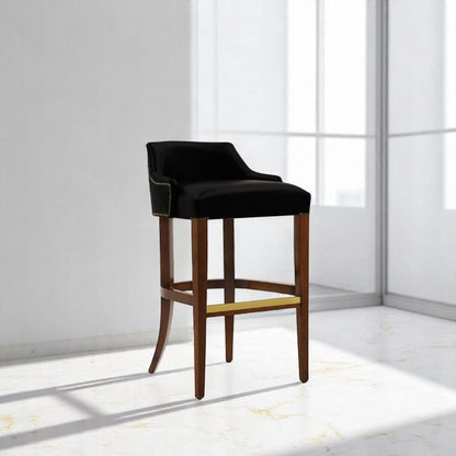 alt="Sleek black bar stool with leather seat and medium oak color legs for a modern look"