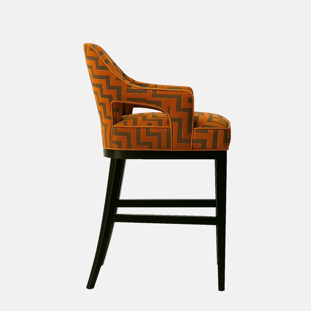 Modern bar stool with a curved backrest and arm design, upholstered in orange fabric with a bold geometric zigzag pattern. The seat is plush and supported by a sleek black wooden frame, combining contemporary style with comfort.