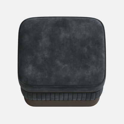 Dark grey upholstered ottoman with ribbed lower panel and smooth cushioned top on wooden base modern square footstool for living room or hotel lounge.