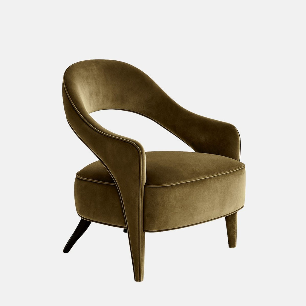 Olive green velvet lounge chair with a sculpted open-back design, curved wraparound arms, and tapered legs.