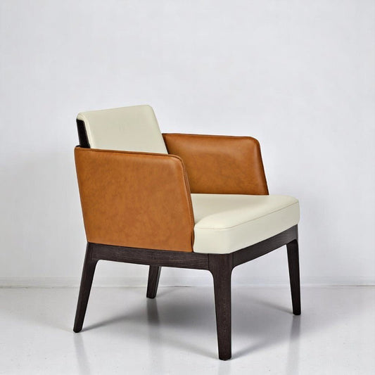 alt="Luxury lounge chair featuring a two-fabric split with dark walnut wood, cream upholstery inside, and tan leather arms"