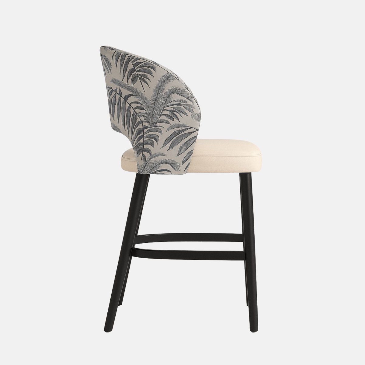 Modern bar stool with curved backrest upholstered in grey fabric with black tropical leaf pattern, cream cushioned seat, and black wooden legs with footrest.