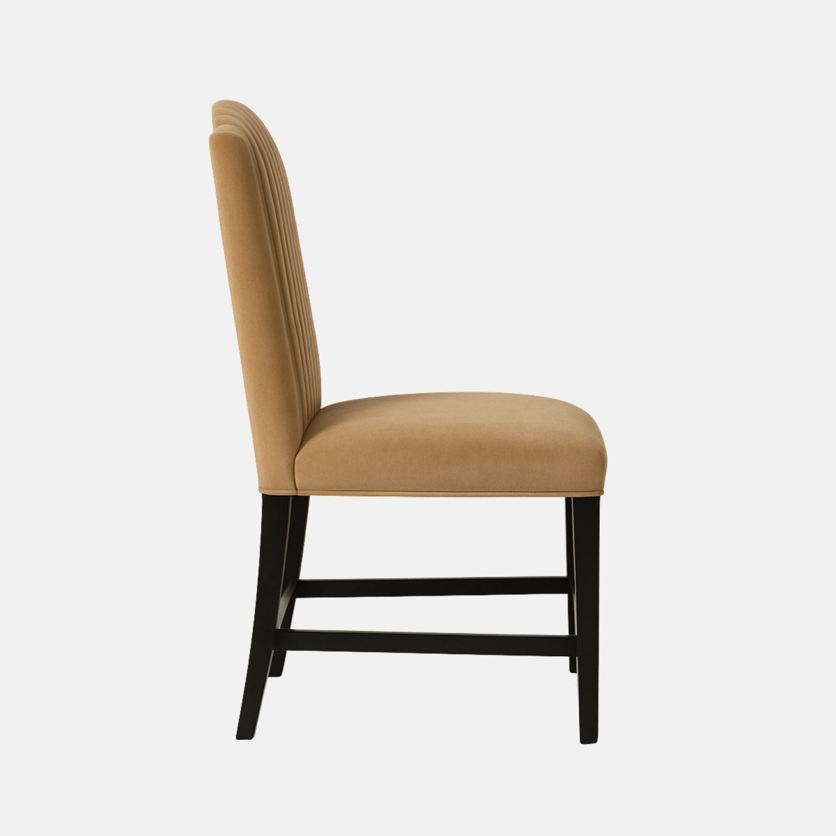 Elegant upholstered dining chair with a curved, vertically channeled backrest in camel-coloured fabric, paired with dark wooden legs