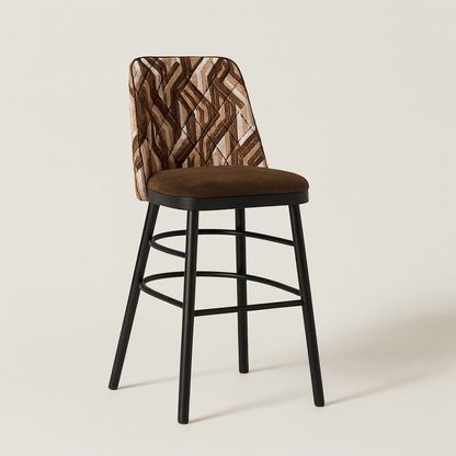 A modern bar stool featuring a geometric patterned fabric backrest with diamond stitching, a chocolate brown velvet seat, and sleek black legs with curved metal footrests, set against a plain off-white background.