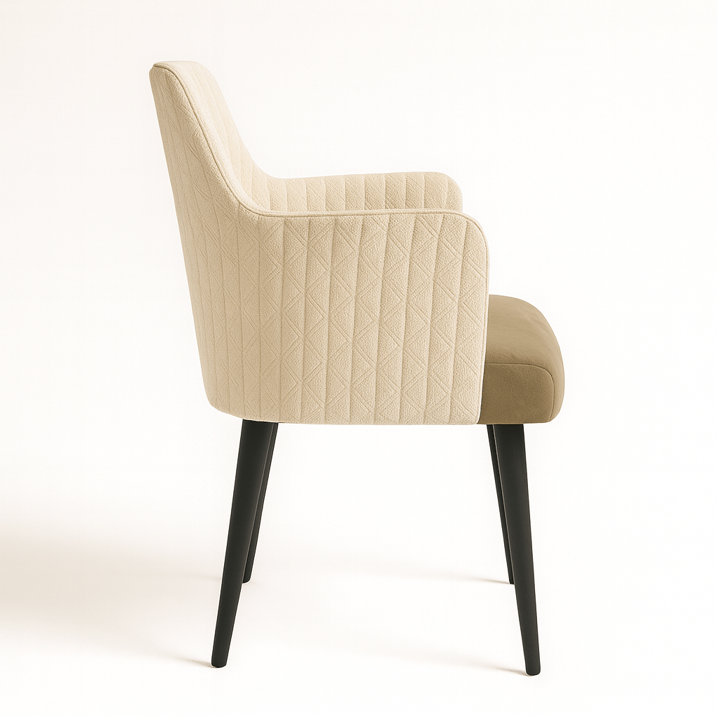 Modern beige upholstered armchair with quilted backrest, taupe seat cushion, and black tapered legs side view on white background