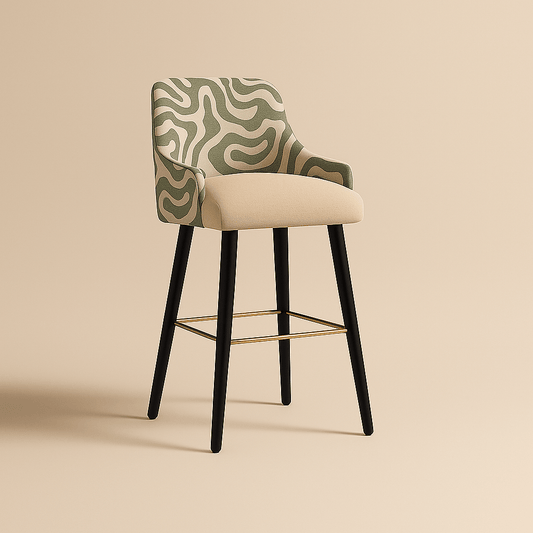 A modern bar stool with a beige upholstered seat and a curved backrest covered in a green and off-white abstract patterned fabric. The stool features sleek black legs and a gold footrest, combining contemporary elegance with subtle artistic flair.
