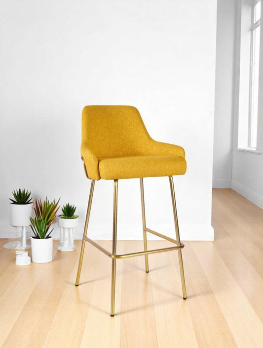 alt="Yellow fabric stool in linen with a gold metal base for contemporary interiors"